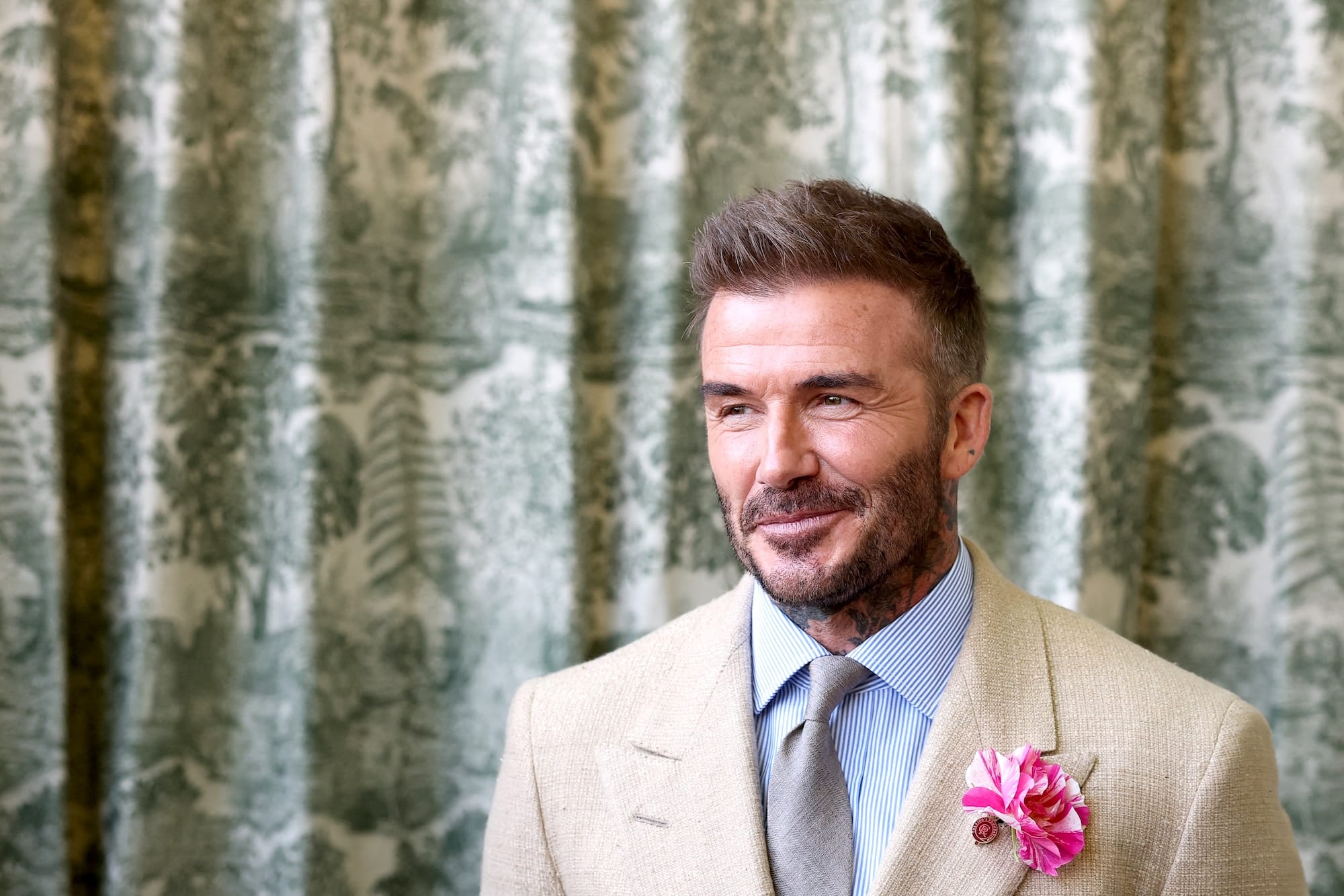 British businessman and retired football player David Beckham reacts as he waits to meet Britain's King Charles III and Britain's Queen Camilla during the preview day at the RHS Chelsea Flower show, in London, on May 19, 2025. (Photo by Toby Melville / POOL / AFP)